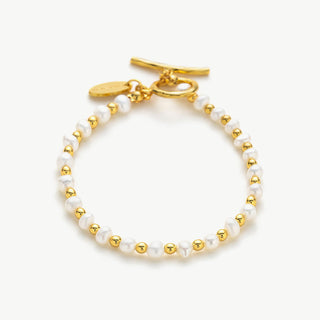 White Freshwater Pearl Bracelet, a symbol of pure elegance, this bracelet features luminous white freshwater pearls arranged in a timeless and classic design, perfect for adding a touch of sophistication to any ensemble.