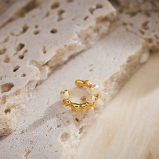 Baroque Pearl Ear Cuff in gold, a gleaming and stylish piece that enhances your look with a warm and luminous glow.
