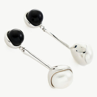 Silver Agate and Pearl Charm Earrings featuring sculpted charm details, these hoops provide a unique and artistic charm, capturing attention with their intricate design.