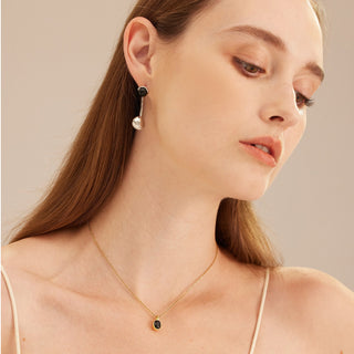 Silver Agate and Pearl Charm Earrings featuring sculpted charm details, these hoops provide a unique and artistic charm, capturing attention with their intricate design.