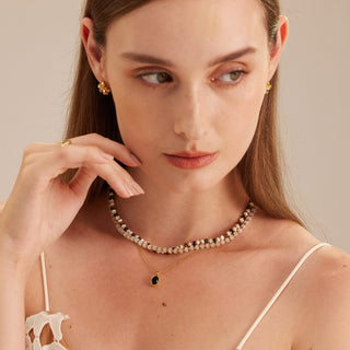 Gold Stone Beaded Necklace, a radiant charm adorned with stones and complemented by gleaming gold accents, capturing the essence of luxury and creating a stylish and timeless accessory.